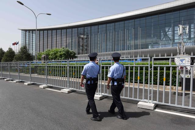 Police officers patrol outside the China National Convention Center, the venue for the upcoming Belt and Road Forum for International Cooperation, in Beijing on May 11. China hosts on May 14 a summit showcasing its ambitious drive to revive ancient Silk Road trade routes and lead a new era of globalisation, just as Washington turns inward in favour of “America First” policies. (AFP Photo) Police officers patrol outside the China National Convention Center, the venue for the upcoming Belt and Road Forum for International Cooperation, in Beijing on May 11. China hosts on May 14 a summit showcasing its ambitious drive to revive ancient Silk Road trade routes and lead a new era of globalisation, just as Washington turns inward in favour of “America First” policies. (AFP Photo)
