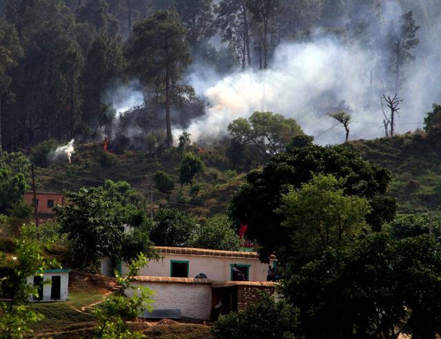 Smoke billows after a mortar shell fired by the Pakistani army explodes in Rajouri district on Saturday. (PTI) Smoke billows after a mortar shell fired by the Pakistani army explodes in Rajouri district on Saturday. (PTI)