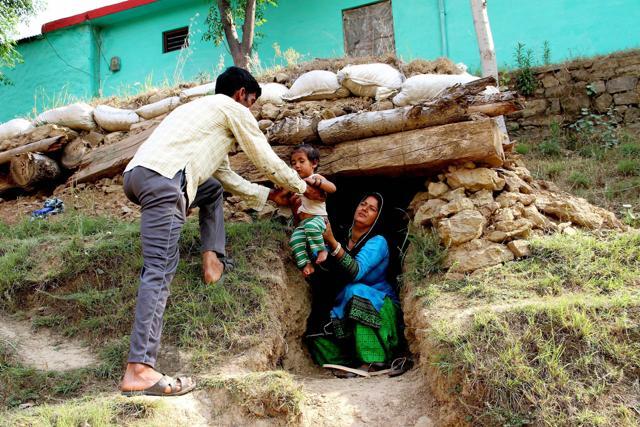 Border residents take shelter in a bunker after Pakistani troops shelled at Nowshera sector of Rajouri district on Saturday. (PTI) Border residents take shelter in a bunker after Pakistani troops shelled at Nowshera sector of Rajouri district on Saturday. (PTI)