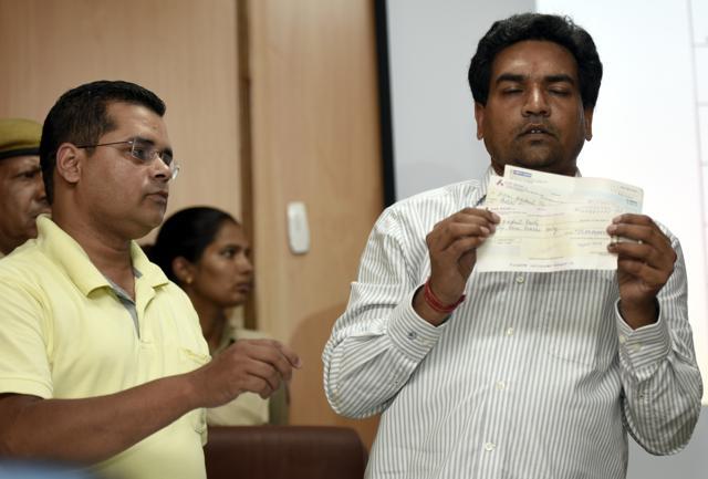 Kapil Mishra shows cheques allegedly received by the Aam Aadmi Party through shell companies. (Sonu Mehta/HT Photo) Kapil Mishra shows cheques allegedly received by the Aam Aadmi Party through shell companies. (Sonu Mehta/HT Photo)