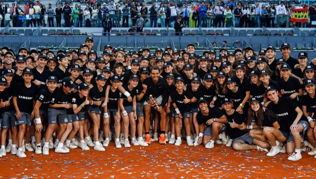 Rafael Nadal poses with ball boys as he celebrates his victory over Austrian tennis player Dominic Thiem at the end of their ATP Madrid Open final on May 14, 2017. Nadal won 7-6 and 6-4. (AFP)