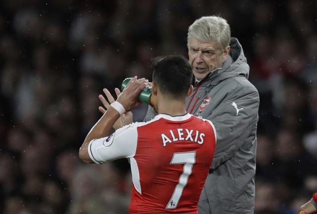 Arsenal's French manager Arsene Wenger talks to Alexis Sanchez during a break in the play during the English Premier League match between Arsenal and Sunderland at the Emirates Stadium in London, Tuesday. (AP) Arsenal's French manager Arsene Wenger talks to Alexis Sanchez during a break in the play during the English Premier League match between Arsenal and Sunderland at the Emirates Stadium in London, Tuesday. (AP)