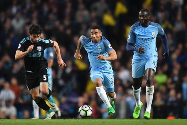 Manchester City's Brazilian striker Gabriel Jesus (C) runs with the ball against West Bromwich Albion's Argentinian midfielder Claudio Yacob (L) during their English Premier League football match at the Etihad Stadium in Manchester on Tuesday. (AFP) Manchester City's Brazilian striker Gabriel Jesus (C) runs with the ball against West Bromwich Albion's Argentinian midfielder Claudio Yacob (L) during their English Premier League football match at the Etihad Stadium in Manchester on Tuesday. (AFP)