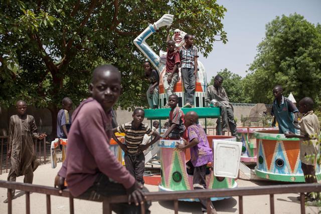 Children orphaned by Boko Haram Islamists play on a merry-go-round in an abandoned amusement park in Maiduguri, Nigeria. In Maiduguri, where the population has doubled to over two million as a result of Boko Haram insurgency, thousands of children are homeless. (AFP) Children orphaned by Boko Haram Islamists play on a merry-go-round in an abandoned amusement park in Maiduguri, Nigeria. In Maiduguri, where the population has doubled to over two million as a result of Boko Haram insurgency, thousands of children are homeless. (AFP)