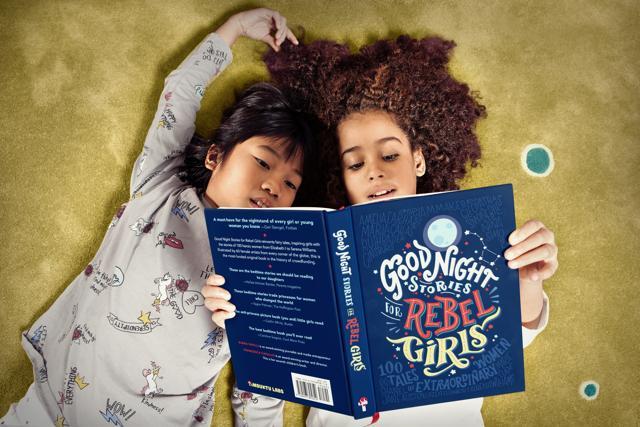 Children read the book Goodnight Stories For Rebel Girls. Children read the book Goodnight Stories For Rebel Girls.