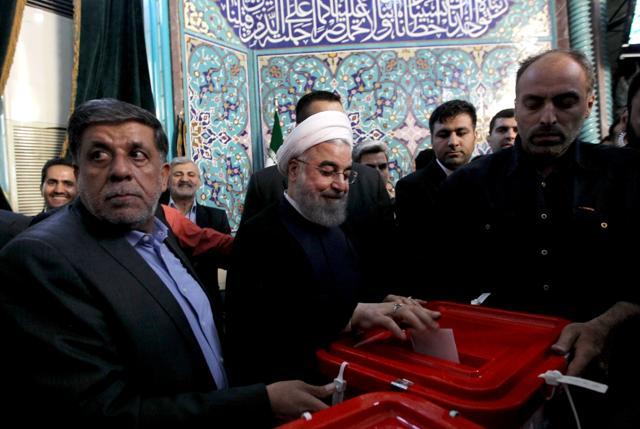 Iranian President and presidential candidate, Hassan Rouhani, casts his ballot for the presidential elections at a polling station in Tehran on May 19, 2017. (AFP Photo) Iranian President and presidential candidate, Hassan Rouhani, casts his ballot for the presidential elections at a polling station in Tehran on May 19, 2017. (AFP Photo)