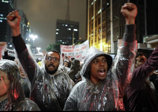 Demonstrators shout slogans against Brazilian President Michel Temer in Sao Paulo. (AP) Demonstrators shout slogans against Brazilian President Michel Temer in Sao Paulo. (AP)
