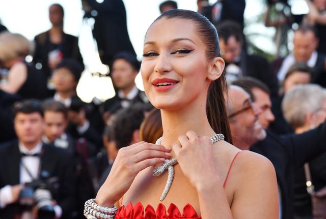 Bella Hadid fixes her necklace on the red carpet. (AFP) Bella Hadid fixes her necklace on the red carpet. (AFP)