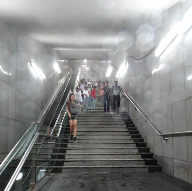 Metro passengers return to the station interior to escape the torrents of rain on Sunday evening. (HT Photo) Metro passengers return to the station interior to escape the torrents of rain on Sunday evening. (HT Photo)