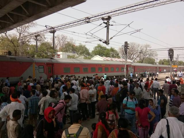 Passengers of the Lokmanya Tilak Express wait after 11 bogies derailed in Unnao. (HT Photo) Passengers of the Lokmanya Tilak Express wait after 11 bogies derailed in Unnao. (HT Photo)