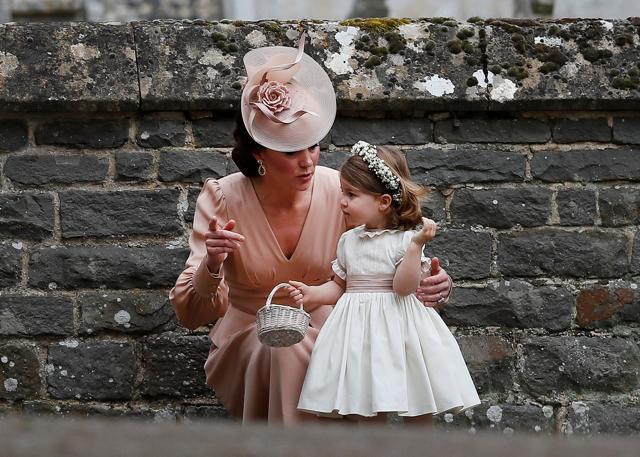 Britain's Catherine, Duchess of Cambridge stands with her daughter Princess Charlotte, a bridesmaid, following the wedding of her sister Pippa Middleton to James Matthews at St Mark's Church in Englefield. (REUTERS) Britain's Catherine, Duchess of Cambridge stands with her daughter Princess Charlotte, a bridesmaid, following the wedding of her sister Pippa Middleton to James Matthews at St Mark's Church in Englefield. (REUTERS)