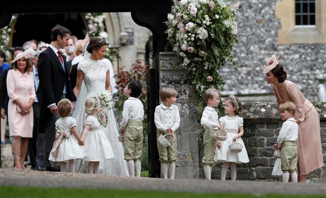 Britain's Catherine, Duchess of Cambridge stands with her son Prince George as she looks across at Pippa Middleton and James Matthews after their wedding at St Mark's Church in Englefield, Britain May. (REUTERS) Britain's Catherine, Duchess of Cambridge stands with her son Prince George as she looks across at Pippa Middleton and James Matthews after their wedding at St Mark's Church in Englefield, Britain May. (REUTERS)