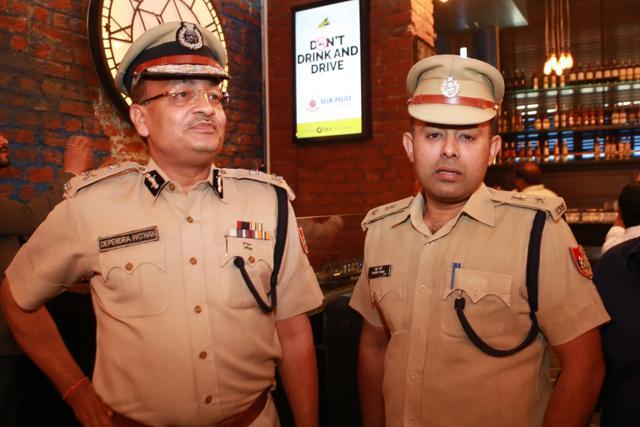 Special commissioner of police, Dependra Pathak and DCP Madhur Verma check out the digital screens. (Amal KS/Hindustan Times)