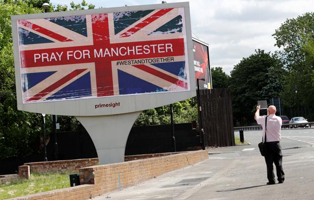 A man photographs a sign in Manchester, Britain. (REUTERS) A man photographs a sign in Manchester, Britain. (REUTERS)