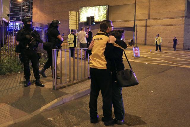 Armed police stand guard at Manchester Arena after reports of an explosion at the venue during an Ariana Grande gig in Manchester on May 22. (AP)