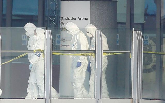 Forensics investigators work at the entrance of the Manchester Arena, Britain May 23. (REUTERS) Forensics investigators work at the entrance of the Manchester Arena, Britain May 23. (REUTERS)
