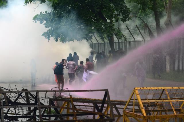 Bangladesh police fire a water cannon as left wing students march in the street towards the Supreme Court to protest in Dhaka on May 26. (AFP Photo) Bangladesh police fire a water cannon as left wing students march in the street towards the Supreme Court to protest in Dhaka on May 26. (AFP Photo)