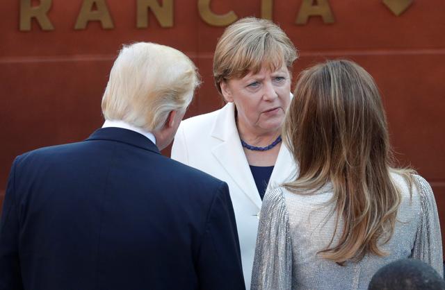 German Chancellor Angela Merkel talks to US President Donald Trump and first lady Melania Trump (REUTERS) German Chancellor Angela Merkel talks to US President Donald Trump and first lady Melania Trump (REUTERS)