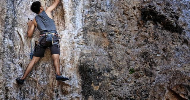 Bouldering involves climbing rocks or walls to a moderate height without ropes or a harness. Bouldering involves climbing rocks or walls to a moderate height without ropes or a harness.