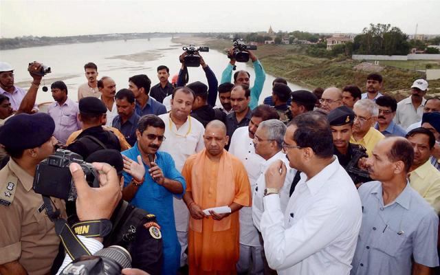 Yogi Adityanath briefed by officials about a bridge on the Ganga in Varanasi on Saturday. (PTI)