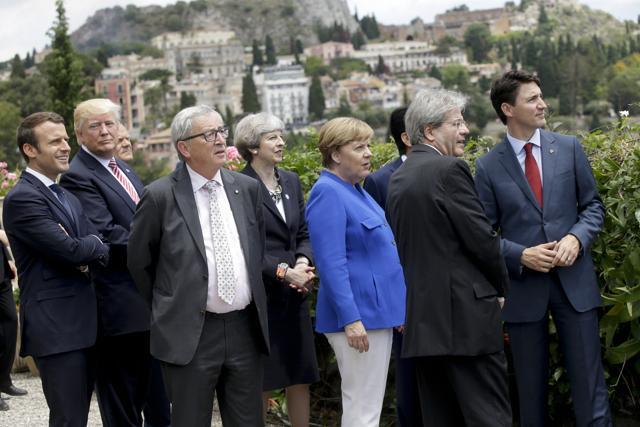 (From left) Emmanuel Macron, Donald Trump, EU Commission president Jean-Claude Juncker, Theresa May, Angela Merkel, Paolo Gentiloni and Justin Trudeau watch the Frecce Tricolori Italian Air Force acrobatic squadron performing. (AP Photo) (From left) Emmanuel Macron, Donald Trump, EU Commission president Jean-Claude Juncker, Theresa May, Angela Merkel, Paolo Gentiloni and Justin Trudeau watch the Frecce Tricolori Italian Air Force acrobatic squadron performing. (AP Photo)