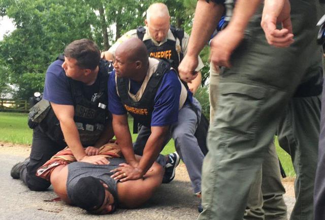 Officers arrest suspect Cory Godbolt on Sunday following several fatal shootings on Saturday in Lincoln County, Mississippi, officials said. (AP Photo) Officers arrest suspect Cory Godbolt on Sunday following several fatal shootings on Saturday in Lincoln County, Mississippi, officials said. (AP Photo)