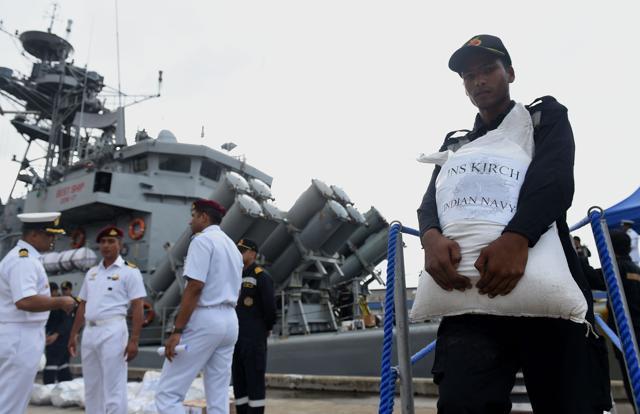 Indian Navy troops offload emergency supplies from the Indian ship Kirch at Colombo harbour in Colombo on May 27, 2017. Indian medical teams and emergency relief arrived in Sri Lanka on May 27 as the monsoon-related death toll crossed 100 and authorities warned of more flooding in low-lying areas. (AFP) Indian Navy troops offload emergency supplies from the Indian ship Kirch at Colombo harbour in Colombo on May 27, 2017. Indian medical teams and emergency relief arrived in Sri Lanka on May 27 as the monsoon-related death toll crossed 100 and authorities warned of more flooding in low-lying areas. (AFP)