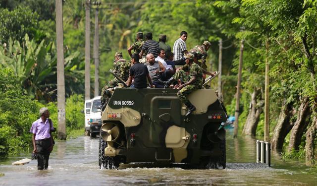 Sri Lankan army soldiers evacuate flood victim stranded at Agalawatte. (AP Photo) Sri Lankan army soldiers evacuate flood victim stranded at Agalawatte. (AP Photo)