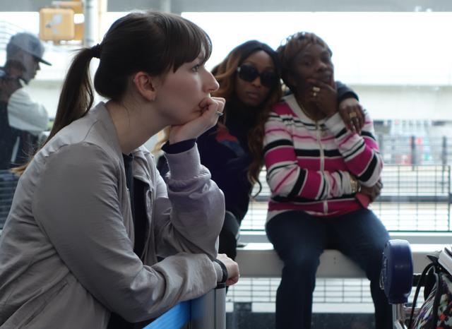 British Airway's passengers wait in line to re-check into an American Airlines flight in John F. Kennedy (JFK) international airport in New York on Saturday. (AFP)