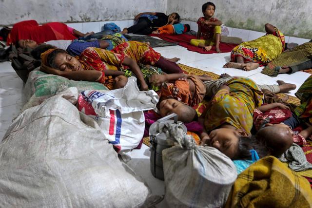 Villagers sleep in a cyclone shelter following an evacuation by authorities in the coastal villages of the Cox's Bazar district. (AFP Photo) Villagers sleep in a cyclone shelter following an evacuation by authorities in the coastal villages of the Cox's Bazar district. (AFP Photo)