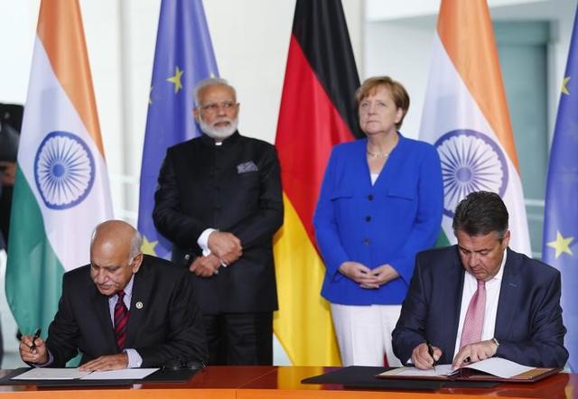 German foreign minister Sigmar Gabriel and India's minister of state for external affairs MJ Akbar sign documents as Prime Minister Narendra Modi and German Chancellor Angela Merkel look on in Berlin on Tuesday. (REUTERS) German foreign minister Sigmar Gabriel and India's minister of state for external affairs MJ Akbar sign documents as Prime Minister Narendra Modi and German Chancellor Angela Merkel look on in Berlin on Tuesday. (REUTERS)