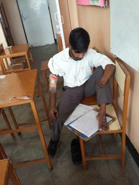 Making notes: Riyaz Ahmed at work. He has perfected the art of writing with his toes after losing both arms in a rail accident. (Handout) Making notes: Riyaz Ahmed at work. He has perfected the art of writing with his toes after losing both arms in a rail accident. (Handout)