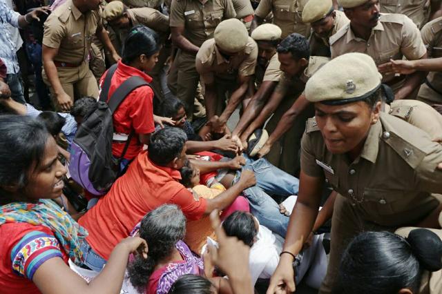 Police personnel try to control a protest by the Students Federation of India(SFI) in Chennai on Wednesday. (HT Photo)