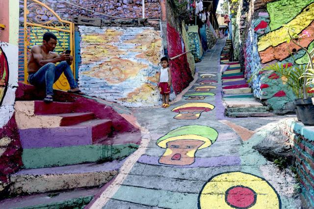 Villagers relax along a path in Semarang. (AFP) Villagers relax along a path in Semarang. (AFP)