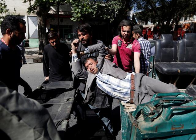 Men move an injured man to a hospital after a blast in Kabul, Afghanistan. (Reuters Photo) Men move an injured man to a hospital after a blast in Kabul, Afghanistan. (Reuters Photo)