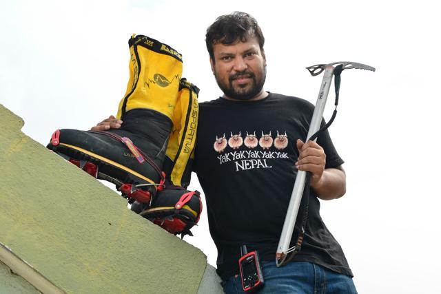 Satyarup Siddhanta poses for a photograph with the equipment he had with him during his successful bid to summit Mount Everest, at his home in Bangalore. (AFP Photo) Satyarup Siddhanta poses for a photograph with the equipment he had with him during his successful bid to summit Mount Everest, at his home in Bangalore. (AFP Photo)