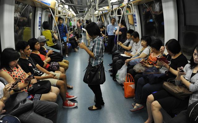 Rail commuters ride a crowded Mass Rapid Transit (MRT) train through the city centre. Opened in 1987 the MRT has a daily ridership of 2.8 million passengers. (Shutterstock) Rail commuters ride a crowded Mass Rapid Transit (MRT) train through the city centre. Opened in 1987 the MRT has a daily ridership of 2.8 million passengers. (Shutterstock)