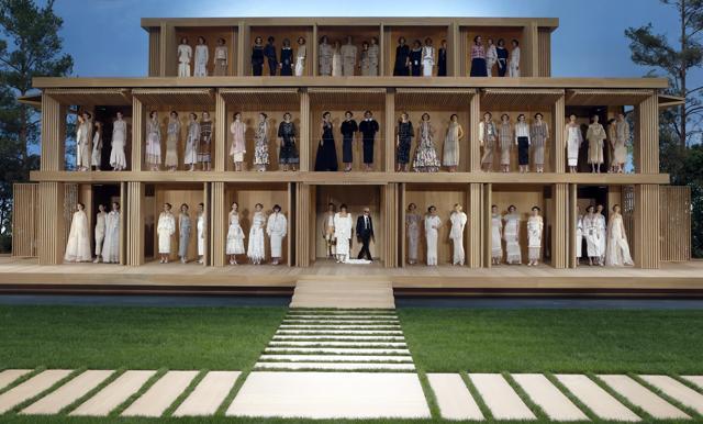 Designer Karl Lagerfeld‘s collection for Chanel Spring-Summer 2016 . The sustainable collection included materials such as wood, straw and paper and the models posed in this wooden ‘doll house’. (AP/Francois Mori) Designer Karl Lagerfeld‘s collection for Chanel Spring-Summer 2016 . The sustainable collection included materials such as wood, straw and paper and the models posed in this wooden ‘doll house’. (AP/Francois Mori)