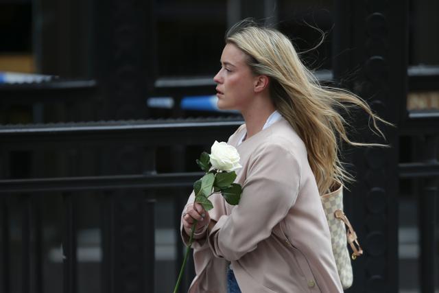 A woman arrives holding a single rose to lay at the police corden at the north end of London Bridge in London. (AFP Photo) A woman arrives holding a single rose to lay at the police corden at the north end of London Bridge in London. (AFP Photo)