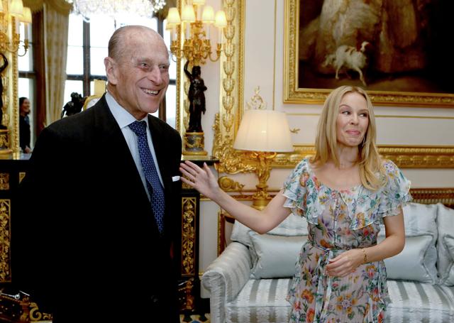 Britain's Prince Philip, Duke of Edinburgh and Patron of the Britain-Australia Society (L) chats with Australian singer, Kylie Minogue at the presentation of the Britain-Australia Society Award for 2016 during a private audience in the White Drawing Room at Windsor Castle, in Berkshire on April 4. (AFP)