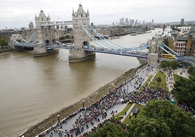 People attend a vigil for victims of Saturday's attack on London Bridge, at Potter's Field Park with Tower Bridge in the background in London. (AP Photo) People attend a vigil for victims of Saturday's attack on London Bridge, at Potter's Field Park with Tower Bridge in the background in London. (AP Photo)
