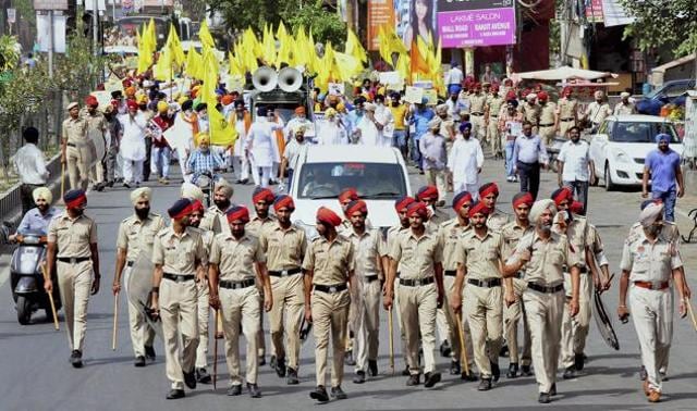 Police walk ahead as activists of Shiromani Akali Dal (Amritsar) holding banners and placards carry out a march amidst high security on the eve of the 33rd anniversary of Operation Bluestar in Amritsar on Monday. (PTI Photo) Police walk ahead as activists of Shiromani Akali Dal (Amritsar) holding banners and placards carry out a march amidst high security on the eve of the 33rd anniversary of Operation Bluestar in Amritsar on Monday. (PTI Photo)