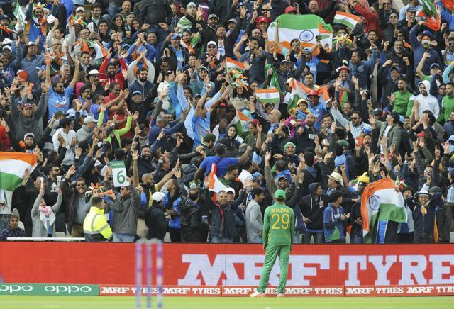 Pakistan's Shadab Khan stands by the boundary as Indian cricket fans cheer for their team during the ICC Champions Trophy match between India and Pakistan at Edgbaston in Birmingham on June 4, 2017. (AP)