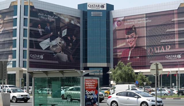 Cars drive past the Qatar Airways office in Doha. (AFP Photo) Cars drive past the Qatar Airways office in Doha. (AFP Photo)