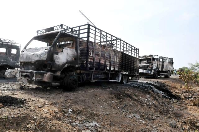 Trucks torched by agitators on the Mhow-Neemuch highway in Mandsaur on Wednesday. (PTI photo) Trucks torched by agitators on the Mhow-Neemuch highway in Mandsaur on Wednesday. (PTI photo)
