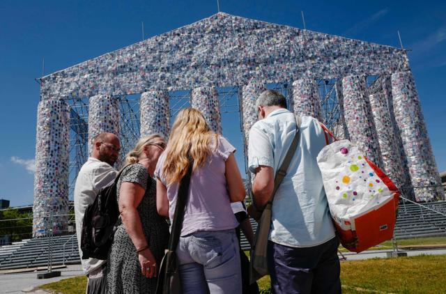 People pause in front of "The Parthenon of Books" . (AFP/John Macdougall) People pause in front of "The Parthenon of Books" . (AFP/John Macdougall)
