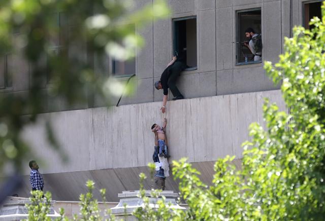 Iranian policemen evacuate a child from the parliament building in Tehran on June 7, 2017 during an attack on the complex. (AFP) Iranian policemen evacuate a child from the parliament building in Tehran on June 7, 2017 during an attack on the complex. (AFP)