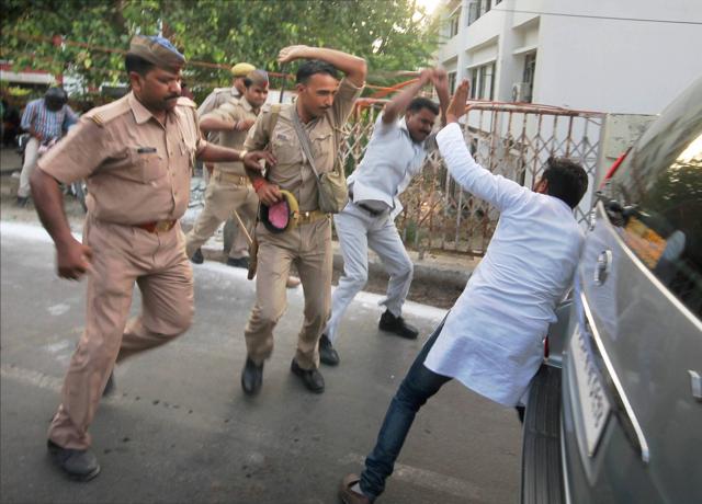 Police and members of Adityanath’s security assault a protester, outside the Lucknow University campus on Wednesday. (PTI PHOTO) Police and members of Adityanath’s security assault a protester, outside the Lucknow University campus on Wednesday. (PTI PHOTO)