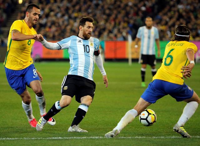 Argentina's Lionel Messi in action against Brazil's Renato Augusto. (REUTERS) Argentina's Lionel Messi in action against Brazil's Renato Augusto. (REUTERS)