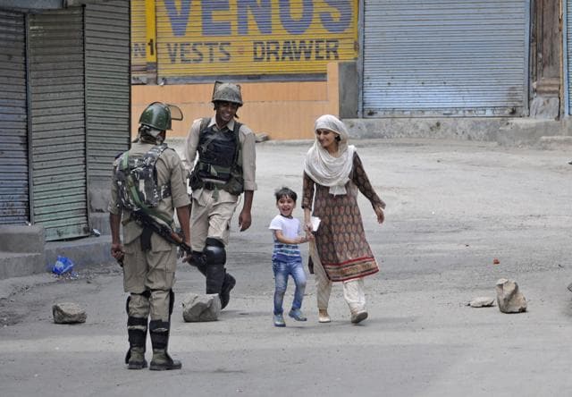 A woman walks with her child during the strike in Srinagar on Friday. (Waseem Andrabi / HT Photo) A woman walks with her child during the strike in Srinagar on Friday. (Waseem Andrabi / HT Photo)